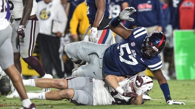 Ole Miss OL Micah Pettus (57) tackles Mississippi State LB Sherman Timbs (34) in the 2022 Egg Bowl at Ole Miss' Vaught-Hemingway Stadium in Oxford, Miss., Thursday, November 24, 2022.